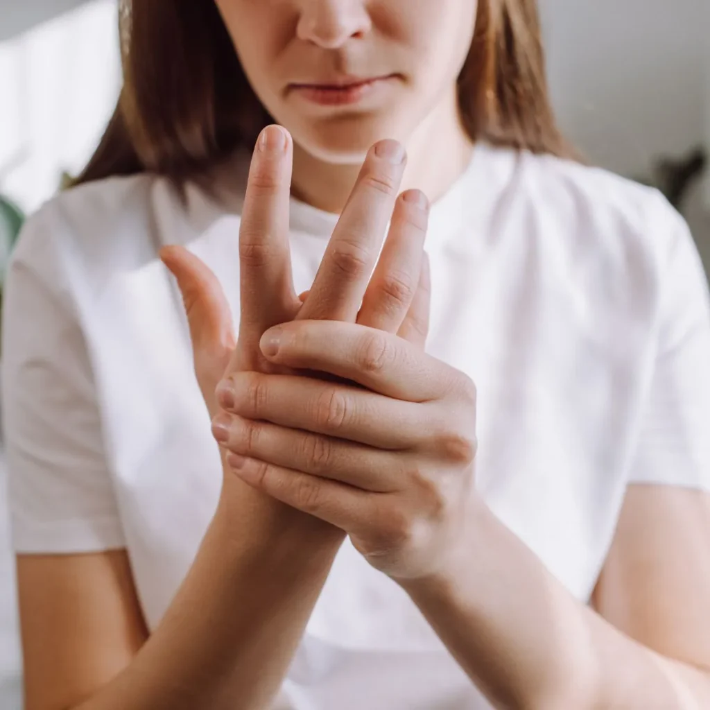 Woman massaging her painful fingers