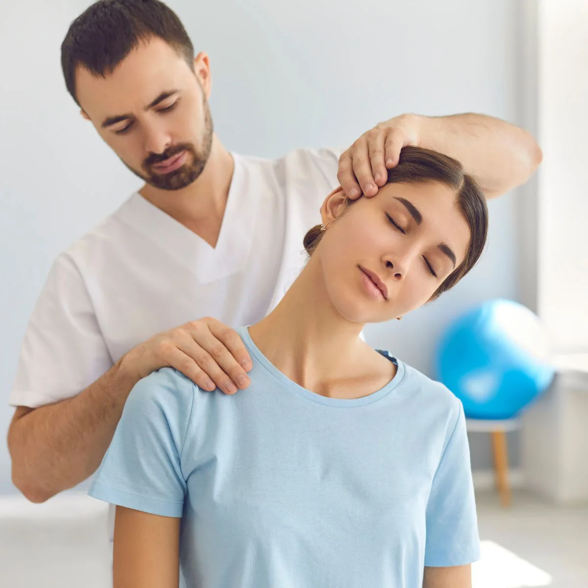 Woman receiving neck adjustment therapy from a practitioner