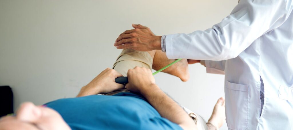 physical therapy patient perform an exercise at the guidance of a physical therapist
